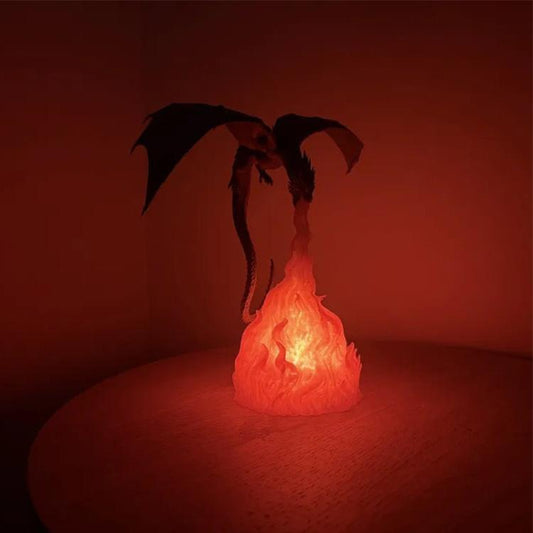 Black dragon night light with orange flames, crouched dragon shape emitting bright glow.