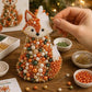 Hand attaching beads to a beaded fox craft tree decoration with orange and pearl beads