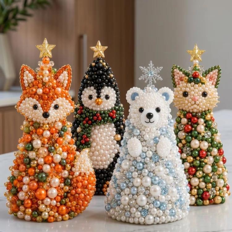 Beaded animal craft tree decorations standing side by side with gold star toppers