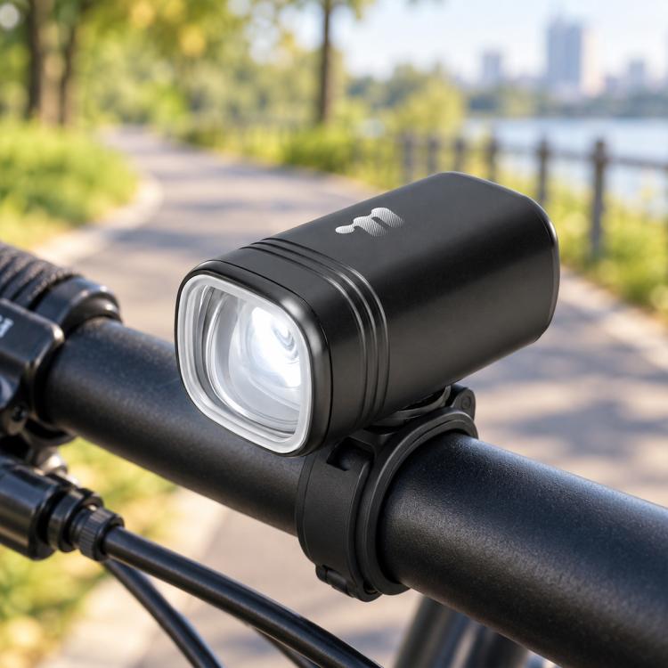 Black bike headlight cylinder with clear front LED lens on handlebar mount