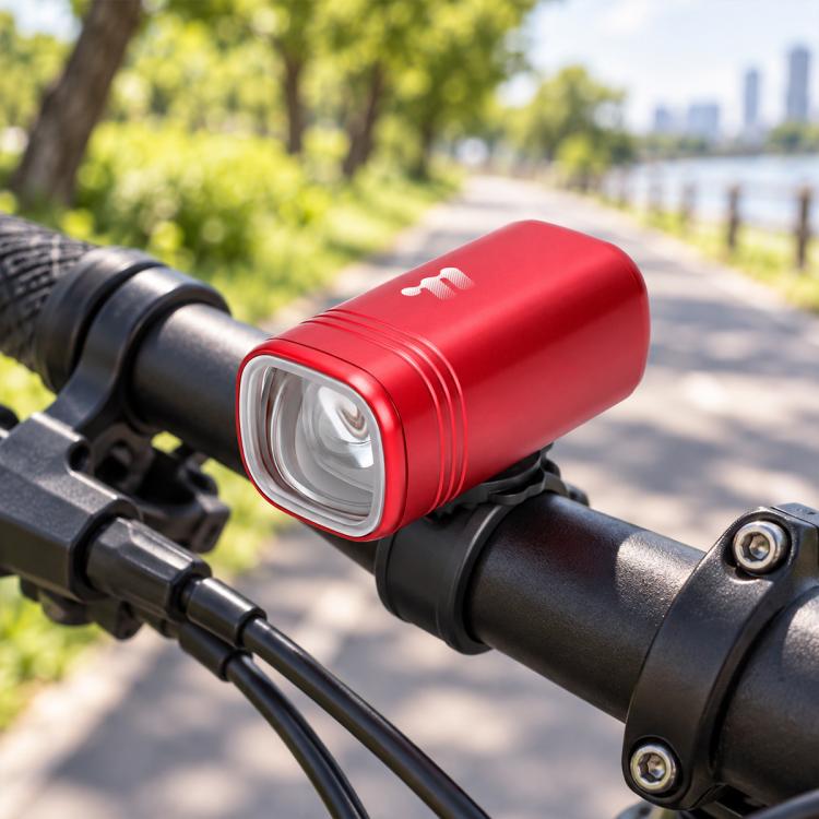 Red bike headlight cylinder with clear front LED lens on handlebar mount