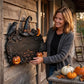 Halloween welcome wooden door sign with witch hat, raven details, crescent moon, and pumpkin faces