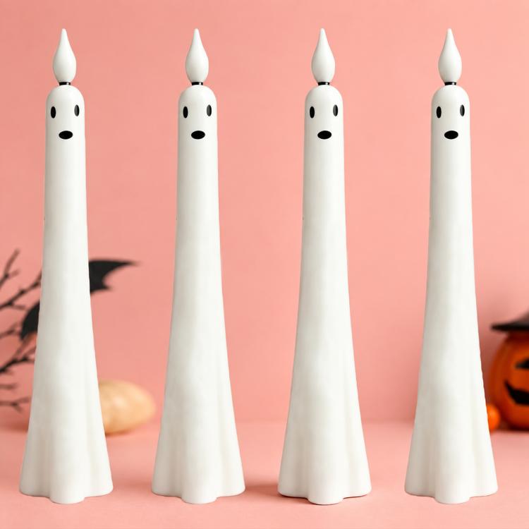 Set of white ghost-shaped LED flameless candles with black face details, upright view
