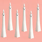Group of white ghost-shaped LED flameless candles with black face details, various sizes