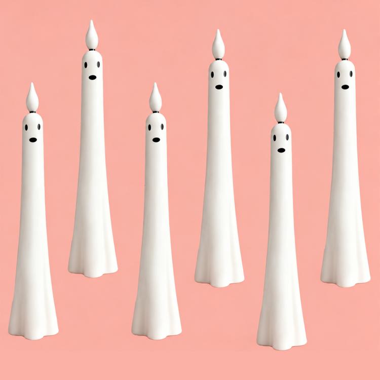 Group of white ghost-shaped LED flameless candles with black face details, various sizes