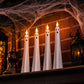 White ghost-shaped LED flameless candles with glowing tips and black face details