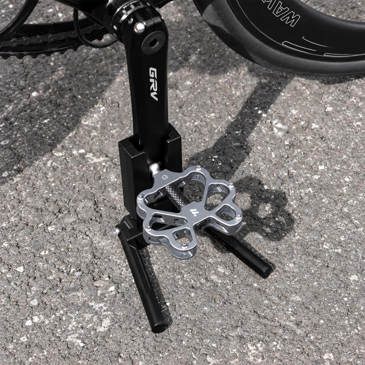 Black bike crank kickstand with folding kick feet and metal mounting bracket
