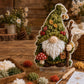3D fabric poke art gnome with green tree-like hat, white beard, and mushroom accents