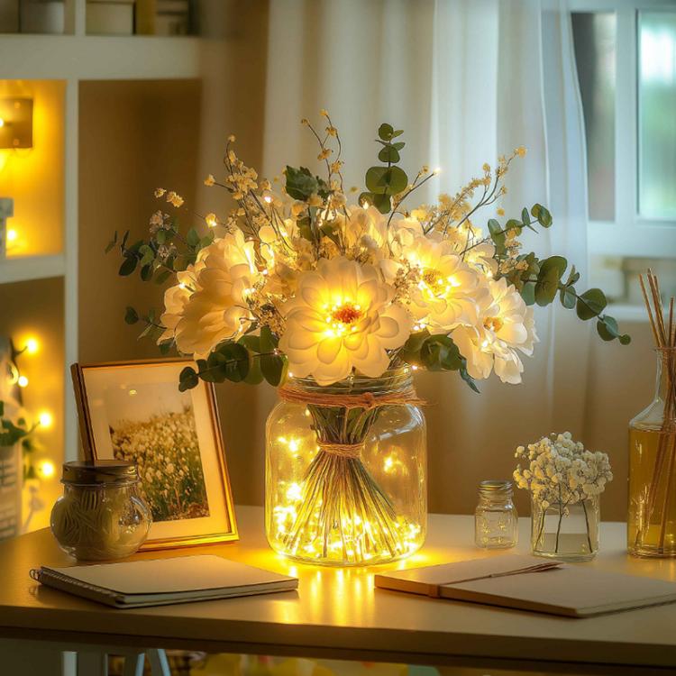 LED faux flower bouquet in clear glass bottle, warm white lights, white blooms and green leaves