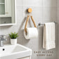 Twine toilet paper holder with rope loop holding a toilet paper roll