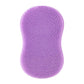 Purple silicone face cleansing brush with dense domed bristle tips on oval pad
