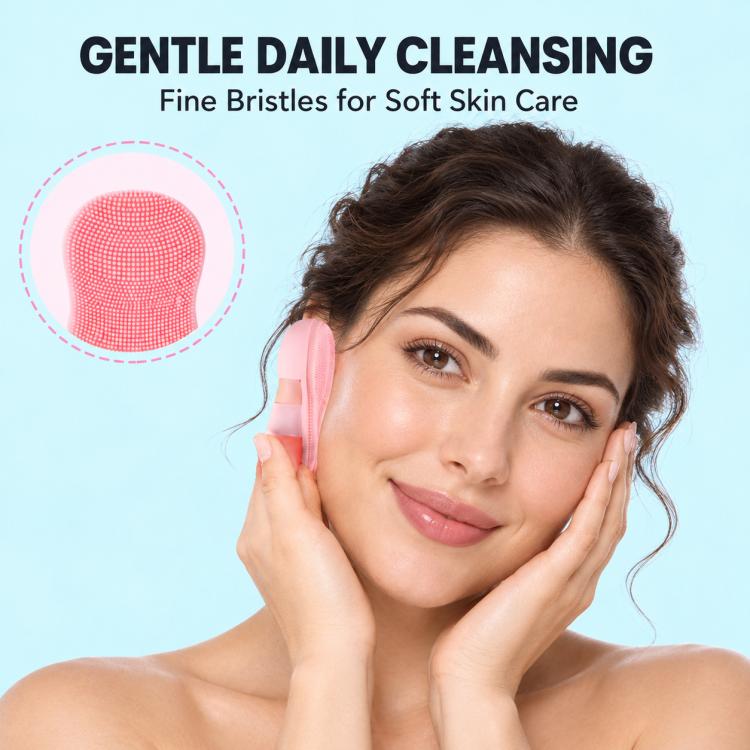 Pink silicone facial cleansing brush pressed to the cheek during skincare