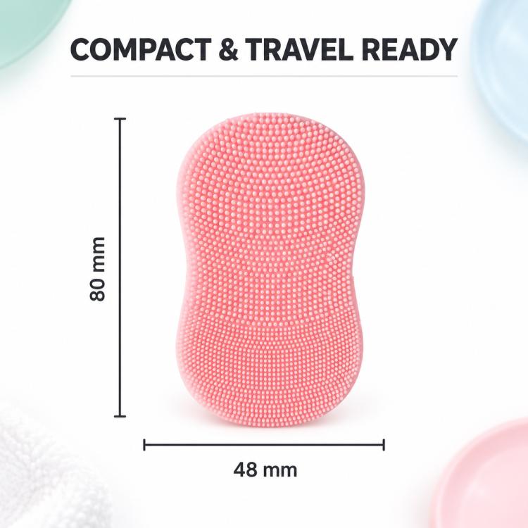 Pink silicone face cleansing brush with domed bristle texture and compact oval shape