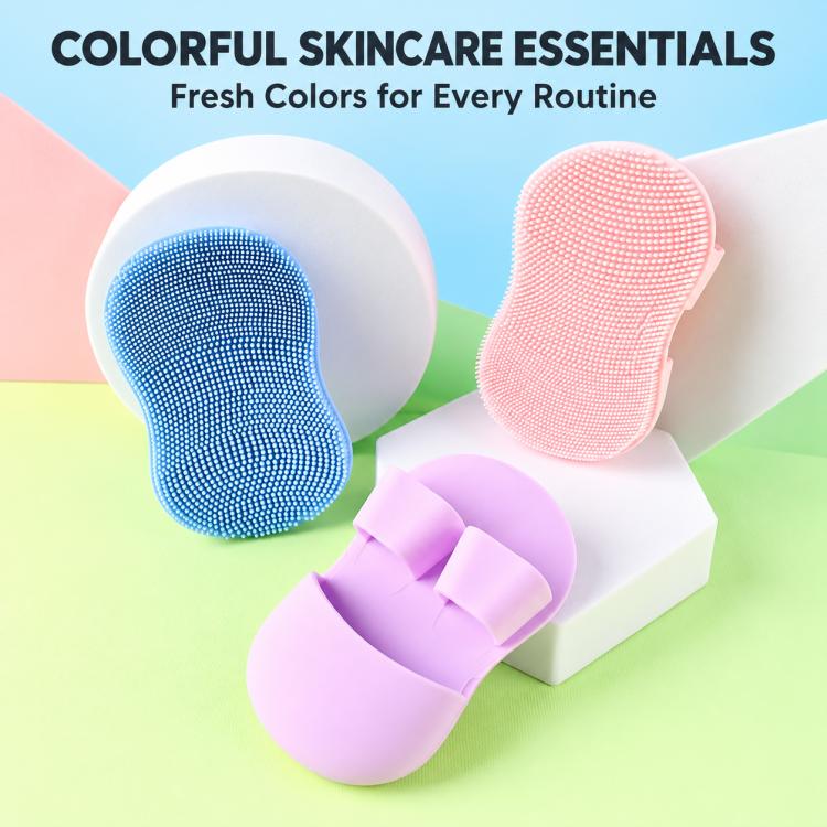 Colorful silicone face cleansing brushes in blue, pink, and purple with finger-grip backs