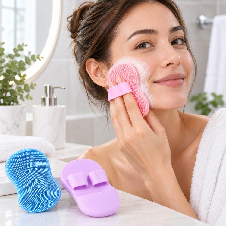 Pink silicone finger face cleansing brush brushing along the cheek area