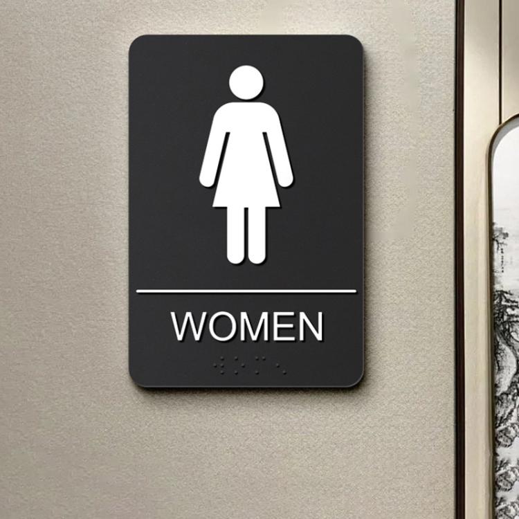 Black Braille sign with raised female icon, tactile dots, and WOMEN label.