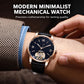Men's automatic mechanical watch on wrist with rose-gold case, blue leather strap, dark dial