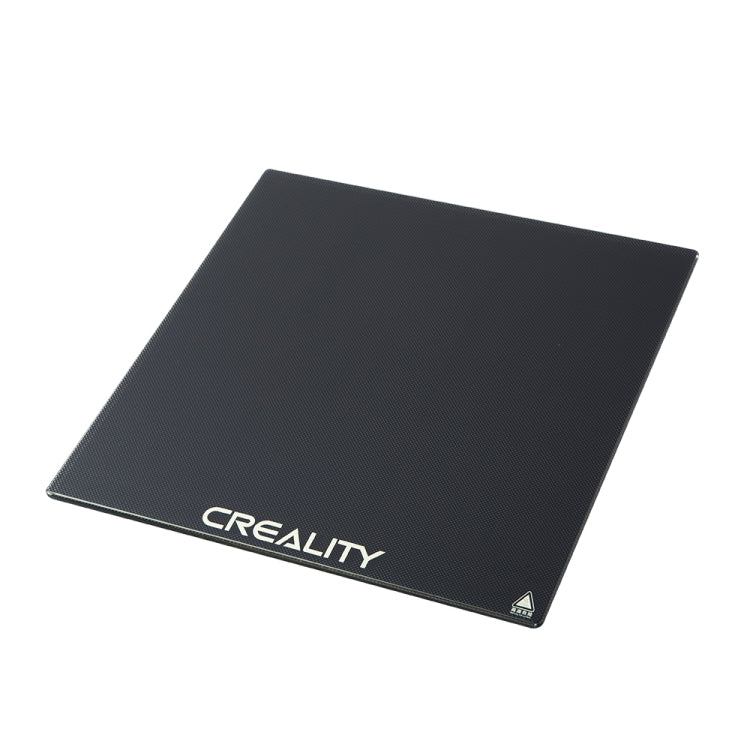 Heated glass build plate with dark surface and CREALITY logo on front edge