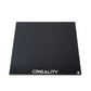 Heated glass build plate with dark surface and CREALITY logo center