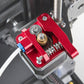 Close-up of red metal Bowden extruder drive with gear and mounting base