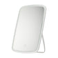 Portable folding LED makeup mirror with white frame and stand, angled front view