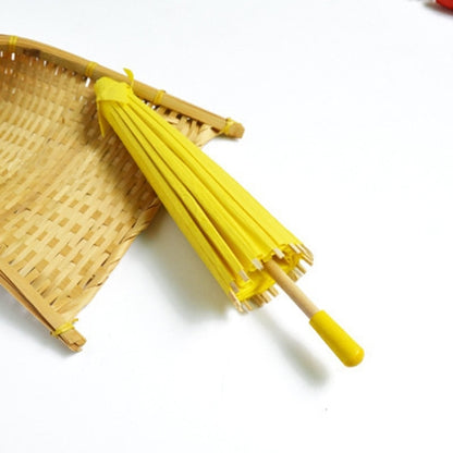 Yellow hanging paper umbrella decoration with bamboo handle and pleated canopy ribs