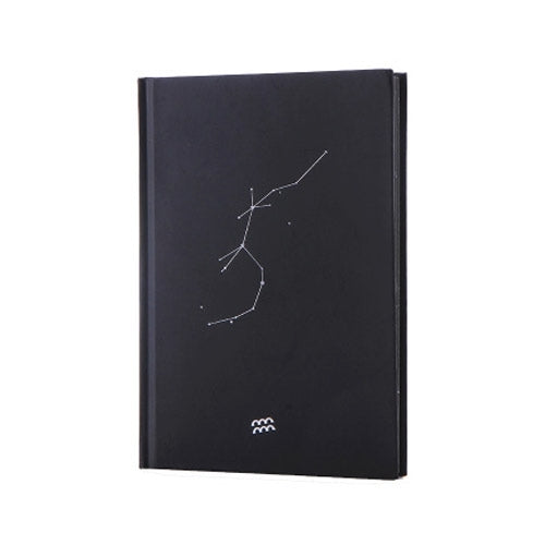 Black paper notebook cover with constellation line art and small star symbol at bottom