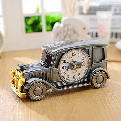 Vintage car model alarm clock, charcoal gray body with gold front and round analog dial