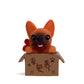 Orange bulldog doll in a brown cardboard box with paw and character prints