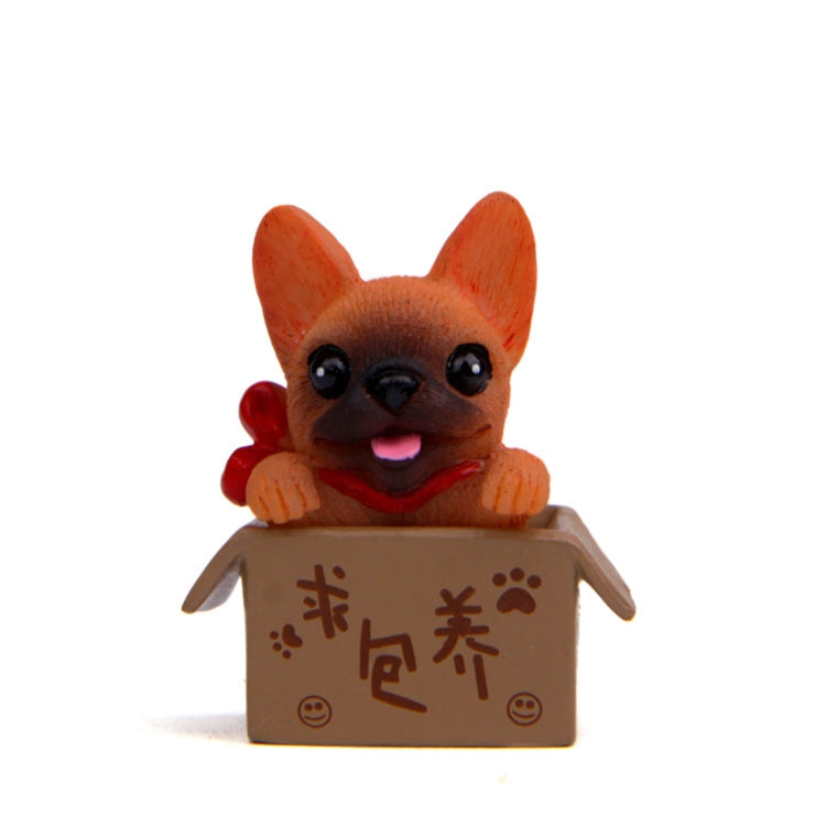 Orange bulldog doll in a brown cardboard box with paw and character prints