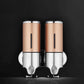 Dual wall-mounted manual soap dispenser, gold and chrome twin bottles