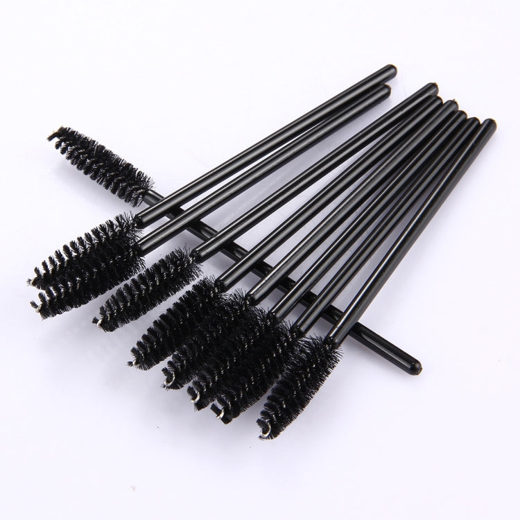 Multiple disposable eyelash mascara wands with black bristles on black handles