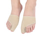 Pair of beige toe correction sleeves on feet with cushioned toe separator pads
