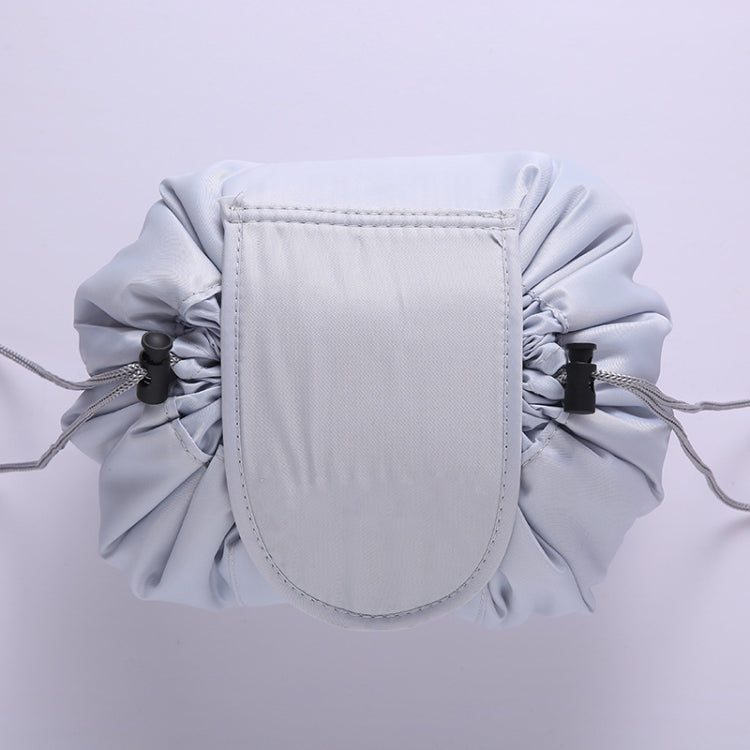 Light gray ruffled drawstring cosmetic pouch with stitched front panel and side drawstrings