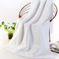 Thick white cotton bath towel with looped terry pile texture