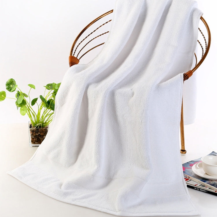 Thick white cotton bath towel with looped terry pile texture