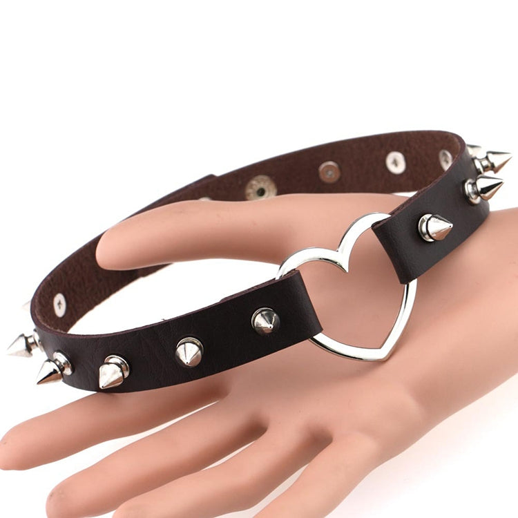 Brown and black leather heart chokers with silver heart pendants and metal spike studs.