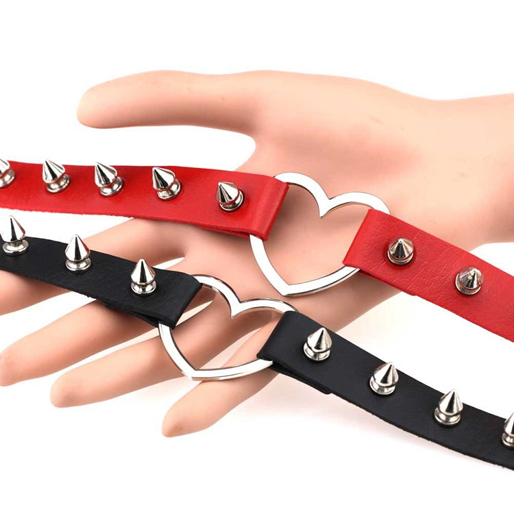 Red and black leather heart chokers with silver heart pendants and metal spike rivets.