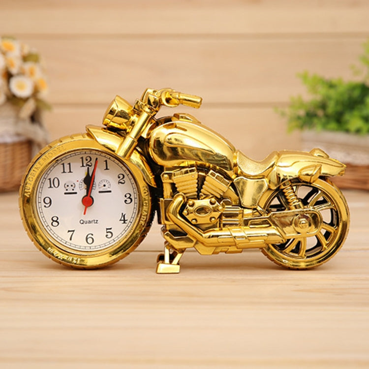 Gold cartoon motorcycle alarm clock with round analog face and red pointer accents