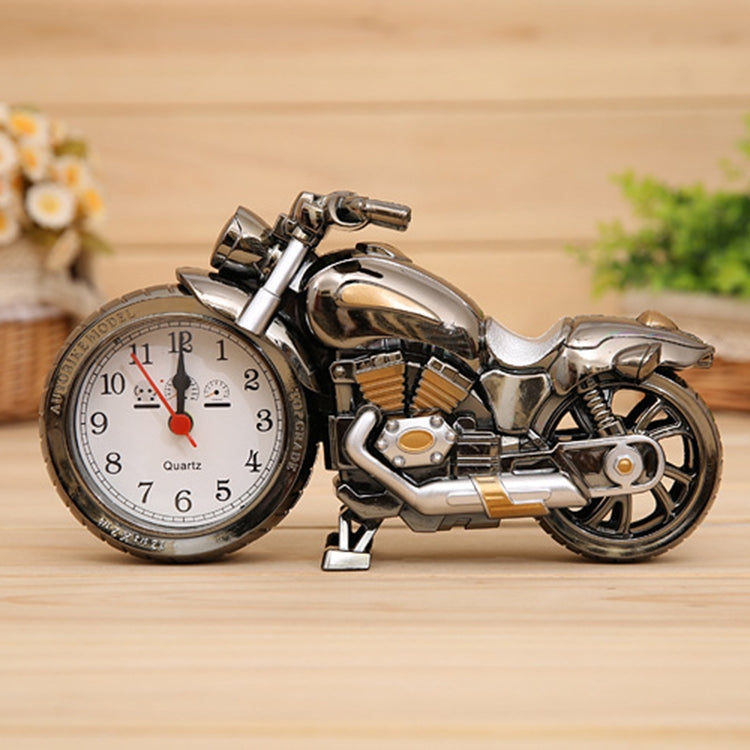 Silver motorcycle alarm clock with analog face and black back battery compartment