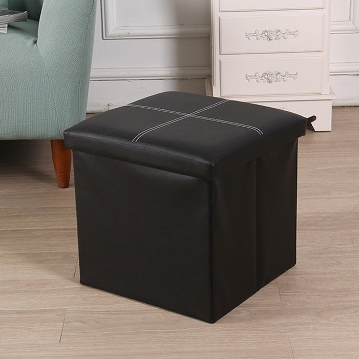 Black folding storage ottoman with stitched crosshatch top and padded lid