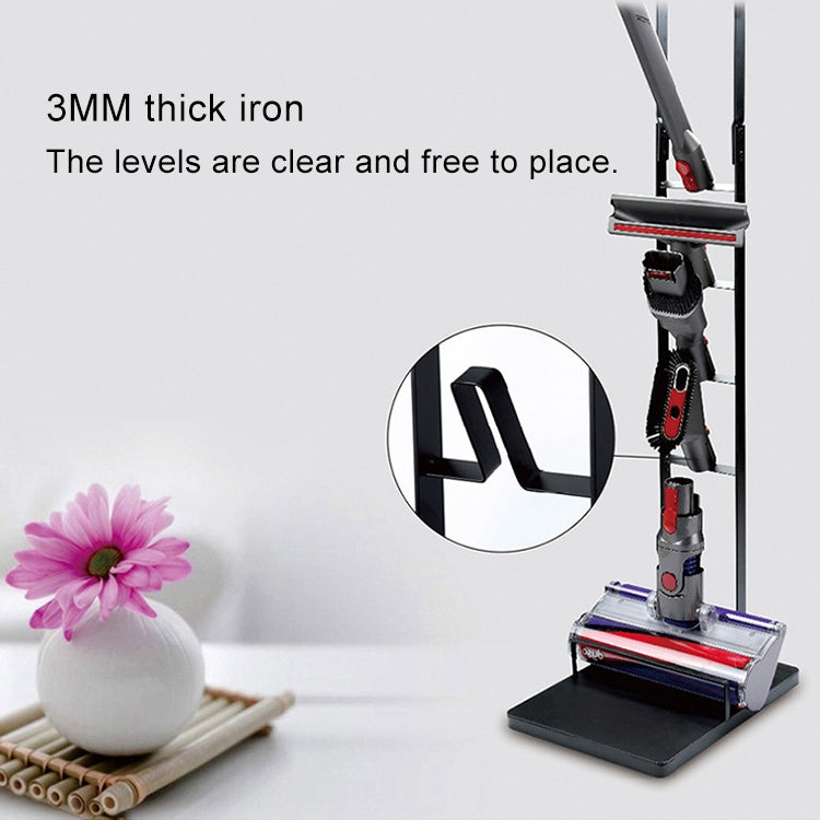 Black metal vacuum storage rack with clear tiers for organizing cleaning tools.