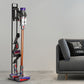 Black vacuum cleaner storage rack with base, holding a cordless stick vacuum upright.