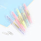 Colorful double-head highlighters in a row, clear barrels with pastel tips