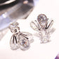 Silver crystal firefly drop earrings with clustered pear stones and wing-shaped accents