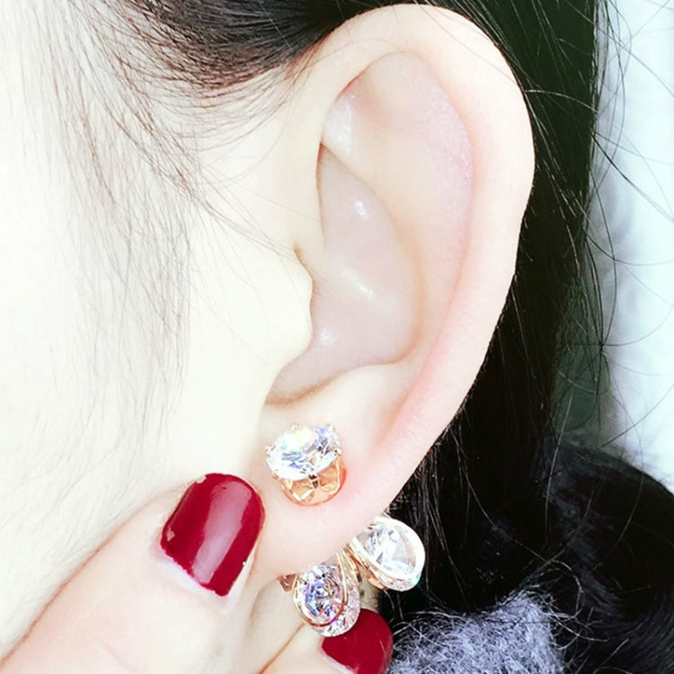 Silver crystal firefly earrings on ear with round and teardrop dangling stones