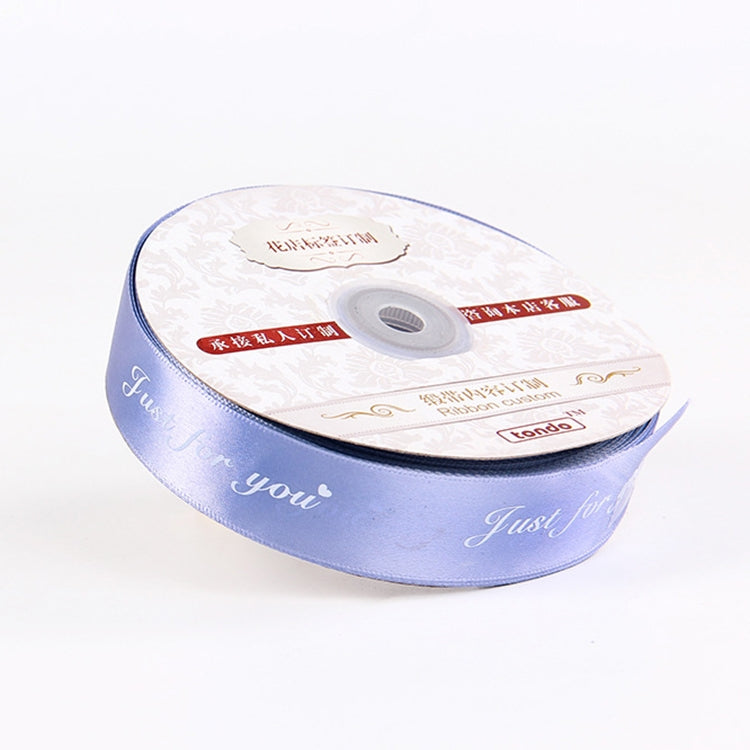 Light blue satin packaging ribbon roll with printed English script and ribbon end