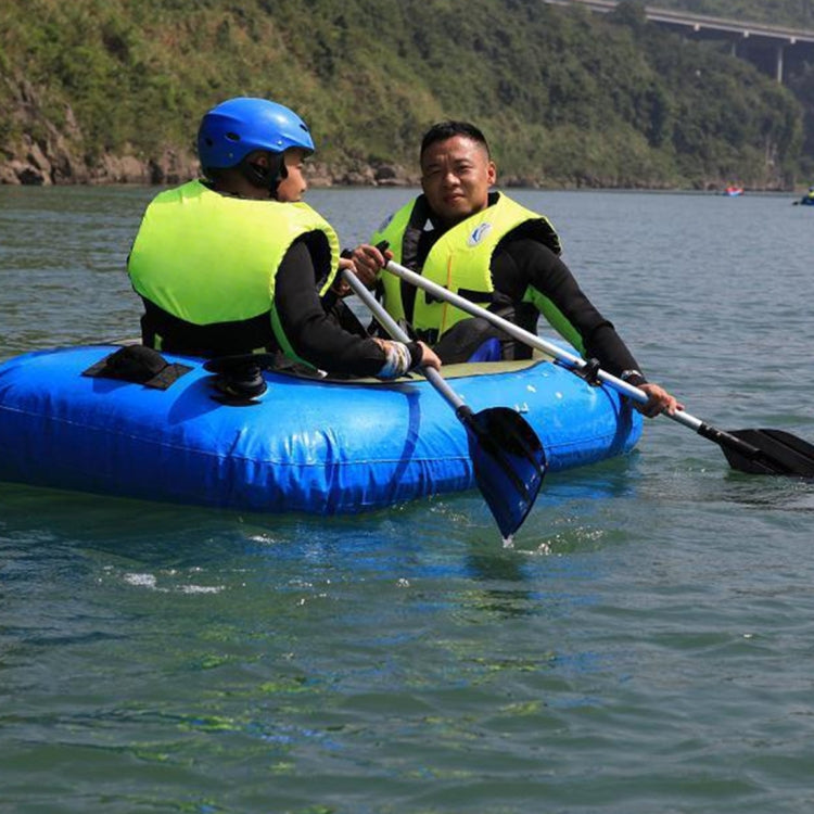 Adult life jacket in neon yellow-green with black straps, shown on a raft