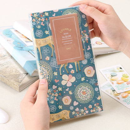 Mini photo album with forest deer pattern cover, blue background and decorative title card.