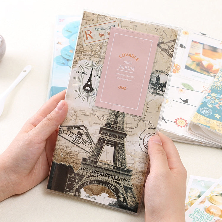 Mini photo album with Eiffel Tower pattern cover, brown and black collage design.